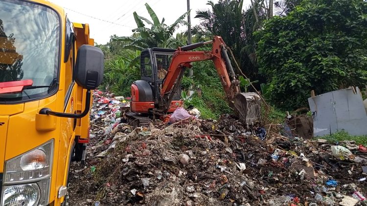 Petugas kebersihan dari DLHP Ambon membersihkan tumpkan sampah di kawasan Air Besar, Ambon, Rabu (14/1/2026)